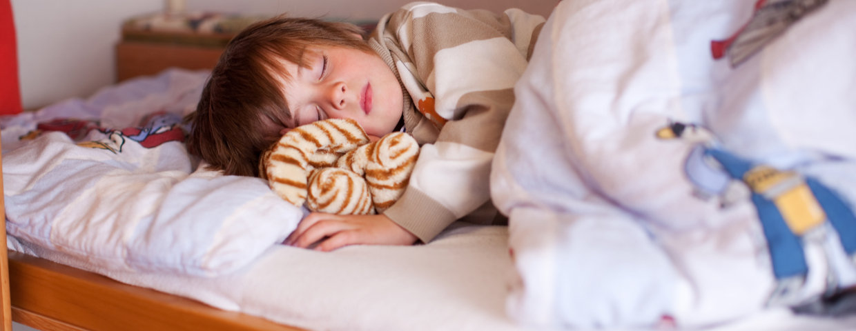 child sleeping peacefully on bed